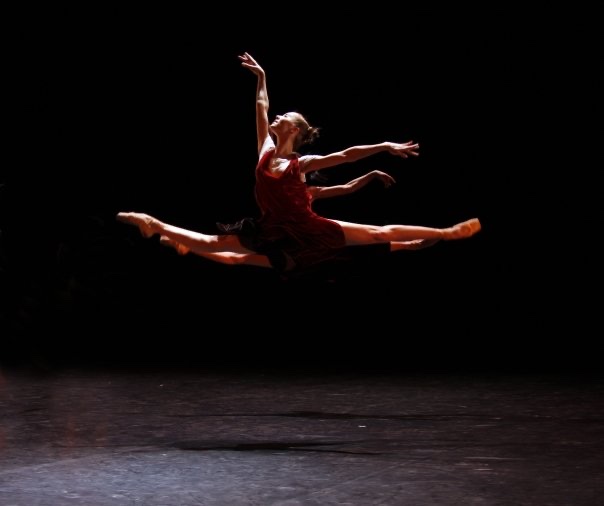 Anastasia Kurkova in a grand jeté in a red dress