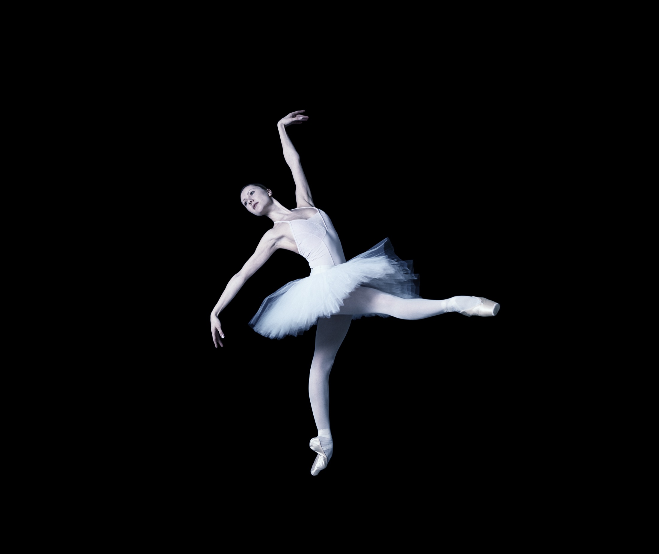 Anastasia Kurkova mid-leap in a white tutu